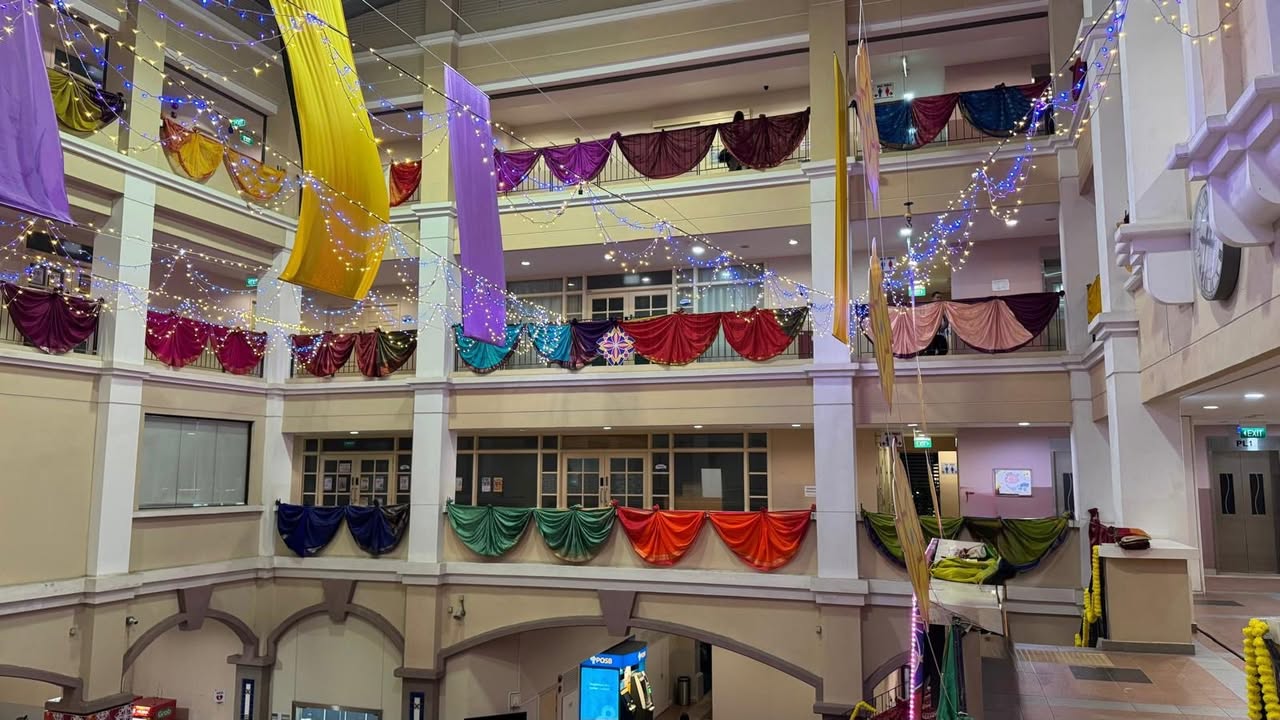 Vibrant hall decor at Elias CC, featuring hundreds of donated sarees gracefully draped.