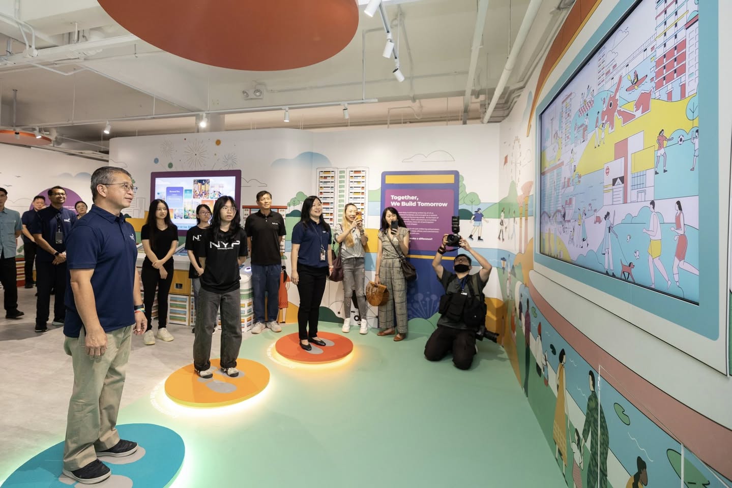 Visitors exploring stories of everyday heroes at Our Community Gallery