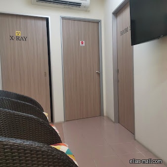 The image shows an interior view of Elias Dental Surgery with doors and seating.